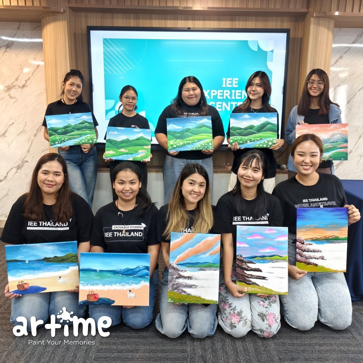 IEE Thailand corporate team with finished paintings at Artime Bangkok workshop / ทีมองค์กรพร้อมผลงานเสร็จที่ Artime ลาดพร้าว